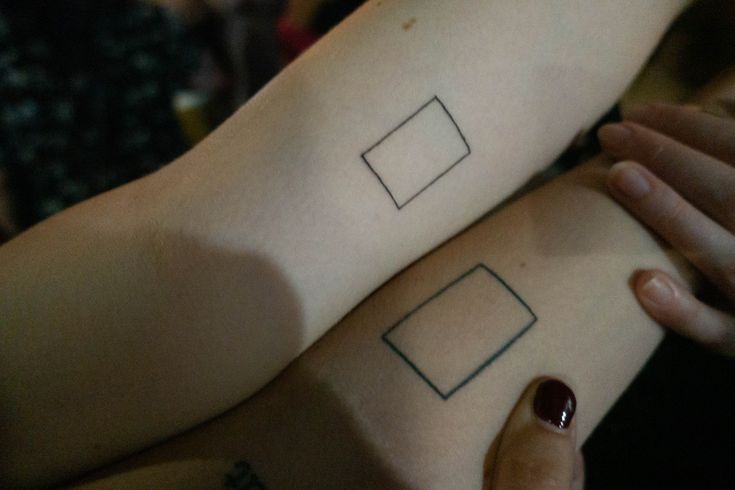 two people with matching tattoos on their arms