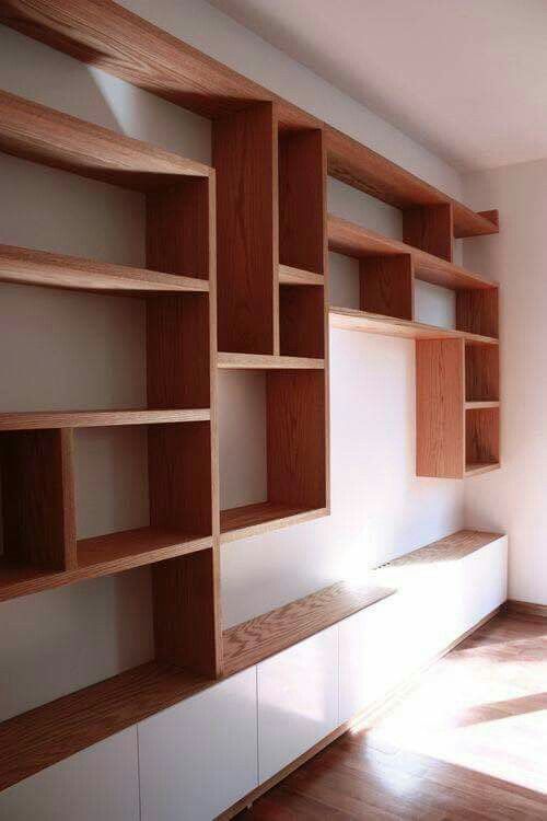 an empty room with wooden shelves and white walls