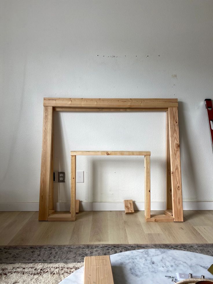 a living room with white walls and wooden furniture on the floor, including a coffee table