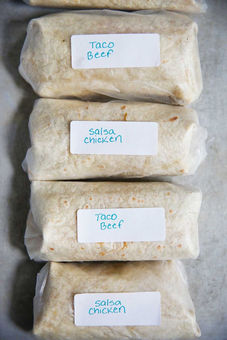 three pieces of food sitting on top of a counter next to each other with labels reading taco beef, salsa chicken and taco beef