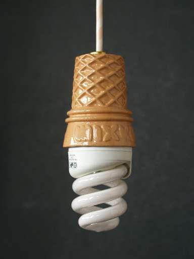 a close up of a light bulb that is turned on and has a cord wrapped around it