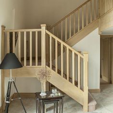 a living room filled with furniture and a stair case