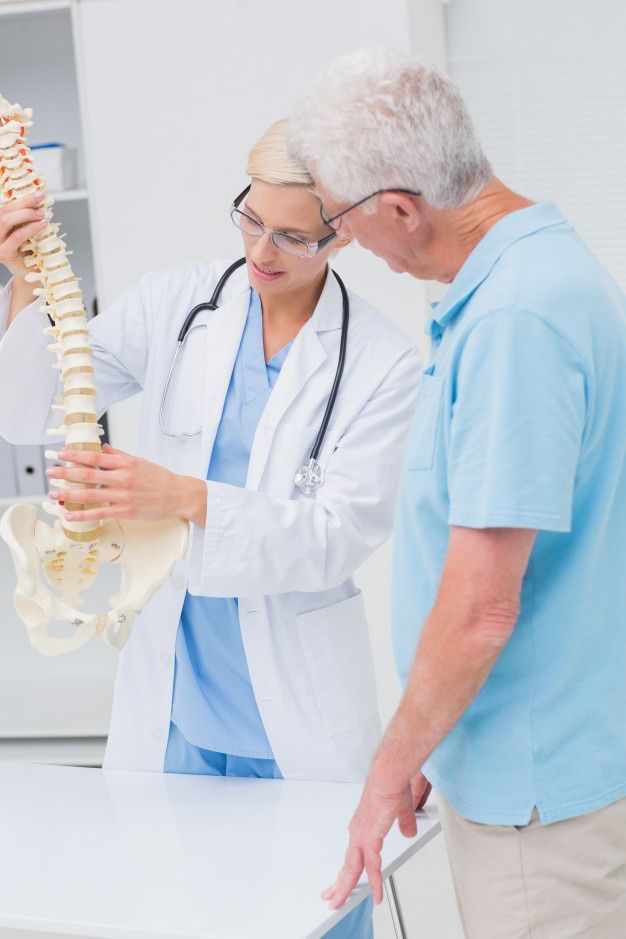 four doctors looking at something on a table