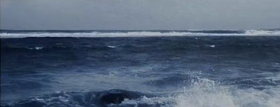 a person riding a surfboard on top of a large wave in the middle of the ocean