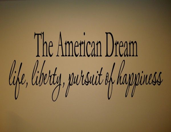 the american dream life liberty pursuit of happiness written in black ink on a white wall