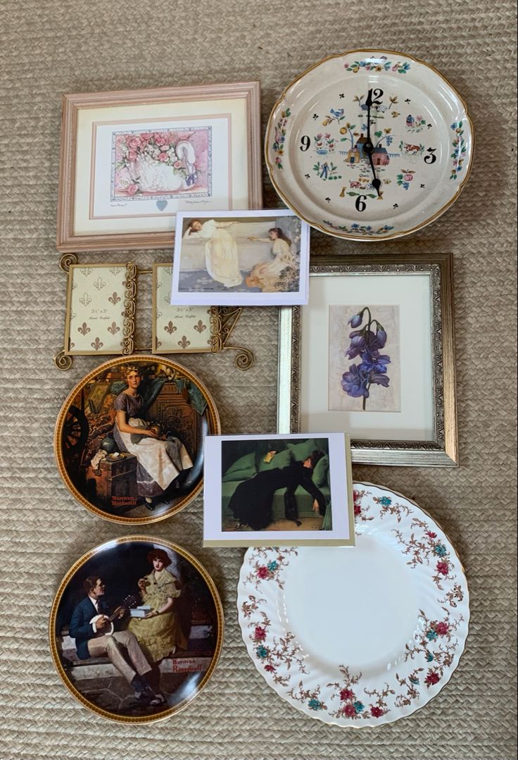 there are many plates and pictures on the floor next to each other, including a clock