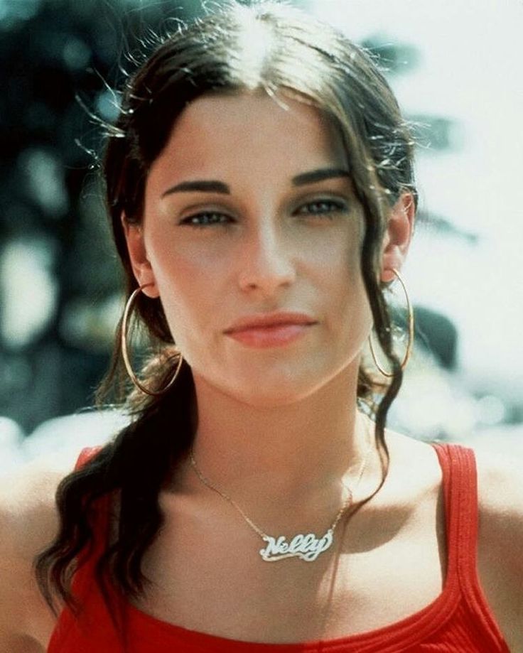 a woman in a red tank top posing for the camera