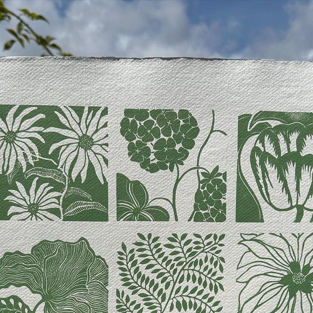 a white towel with green flowers and plants on it