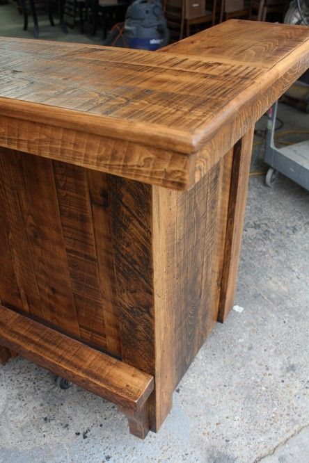 a wooden desk sitting on top of a cement floor