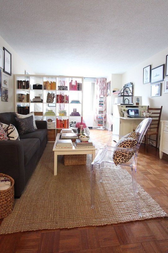 a living room filled with furniture and pictures on the wall