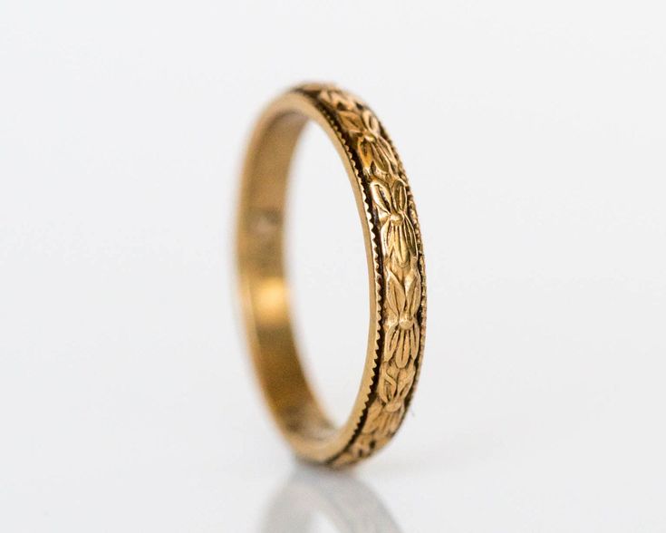 * VIEW A VIDEO OF THIS RING: https://youtu.be/397NvKpaGB4 * Description: Gorgeous antique baby ring circa 1920!. This ring is handcrafted in 14k yellow gold and is the perfect accessory for any baby. The band has a marvelous floral design running along the entire band. This is a true antique piece, and we are honored to offer it to our Etsy family. Item Details: Ring Size: .75 Metal Type: 14K Yellow Gold Weight: 0.6 grams Finger to top of Stone Measurement: 1.12mm Payment & Refund Details: * Antique Engraved Ring With Decorative Band, Antique Engraved Rings For Marriage, Antique Engraved Round Ring For Marriage, Antique Engraved Round Band Ring, Heirloom Yellow Gold Stackable Rings, Antique Engraved 14k Gold Ring With Round Band, Heirloom 14k Gold Rings For Marriage, Yellow Gold Brass Stackable Rings For Wedding, Vintage Stackable Jewelry With Round Band