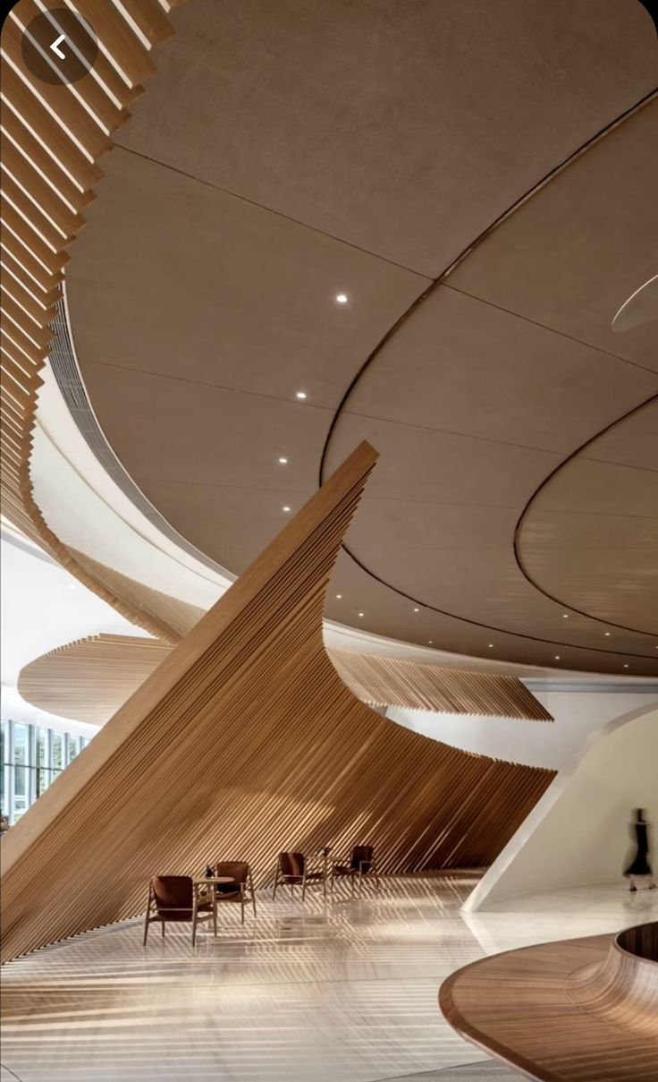 the interior of an office building with wood slats on the ceiling and wooden chairs