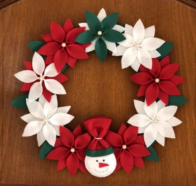 a christmas wreath made out of paper poinsettis