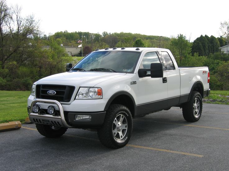 a white pickup truck parked in a parking lot