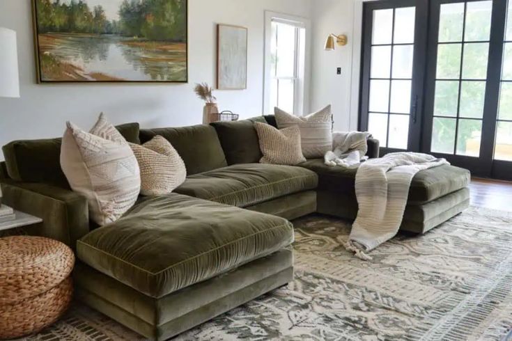 a living room filled with lots of furniture and pillows on top of a large rug