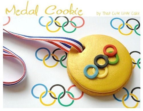 an olympic medal and cupcake on a table