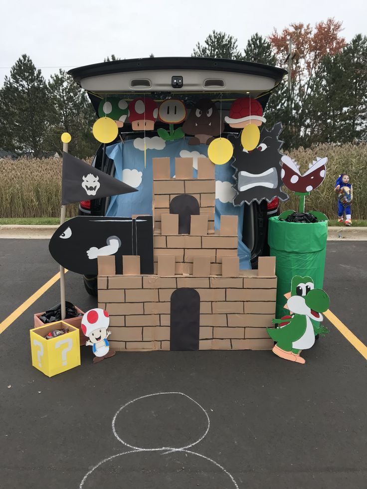 the back of a car with cardboard cutouts and decorations on it's roof