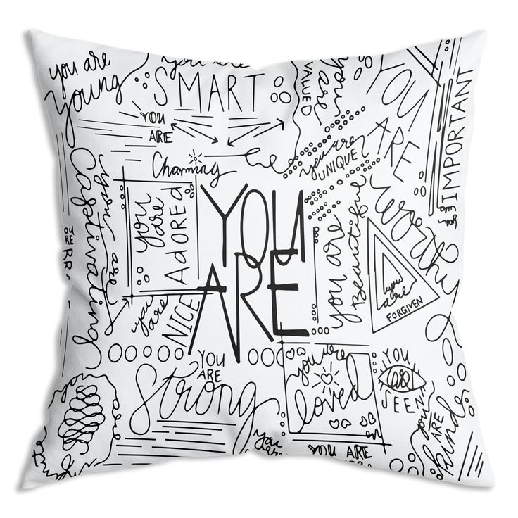 a black and white pillow with the words you're here written on it in cursive writing