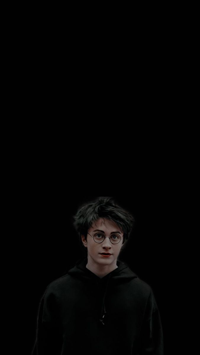 harry potter standing in front of a black background