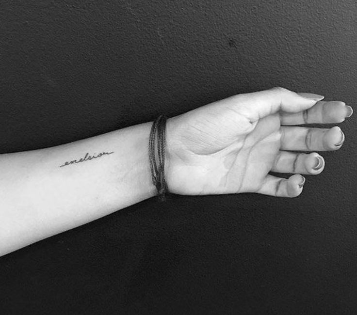 a woman's arm with a small tattoo on it