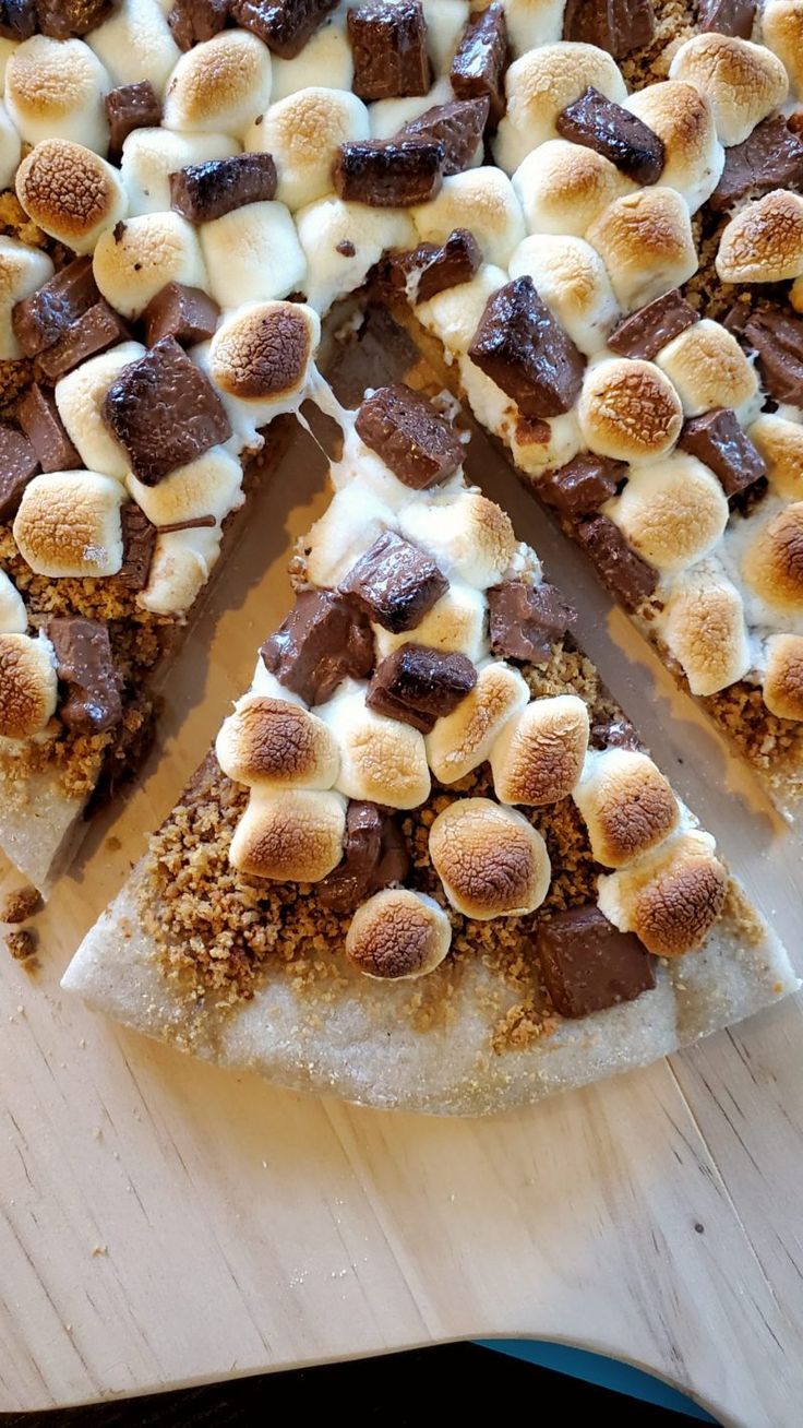 there is a pizza with marshmallows and chocolate topping on the top slice