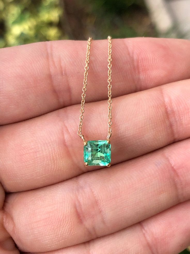 Featured here is a 1.32-carat stunning, Colombian emerald necklace in fine 14K yellow gold. Displayed in the center is a medium-light green emerald with incredible crystal clarity, accented by a simple four-prong gold mount, allowing for the emerald to be shown in full view. The earth mined, green Colombian emerald has a desirable lush green color with excellent qualities. An 18 inch is attached to the emerald pendant. This necklace is ideal for everyday use and is the perfect accessory to any o Dainty Luxury Emerald Necklace As Birthstone, 14k Gold Emerald Cut Solitaire Necklace, Green Emerald Baguette Cut Necklace, 14k Gold Emerald Cut Fine Jewelry Necklace, Emerald Cut Solitaire Necklace In 14k Gold, Fine Jewelry May Birthstone In Baguette Cut, Fine Jewelry With Baguette Cut May Birthstone, Baguette Cut Emerald Necklace As Gift, Emerald Baguette Cut Necklace As Gift