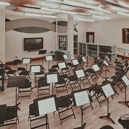 an empty room with lots of chairs and musical instruments