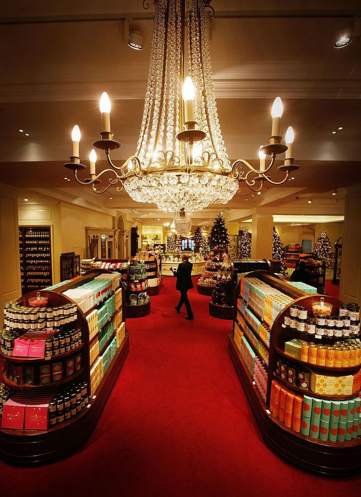 a store filled with lots of different types of goods and lights hanging from the ceiling