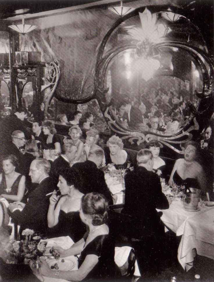 a group of people sitting at tables in a room