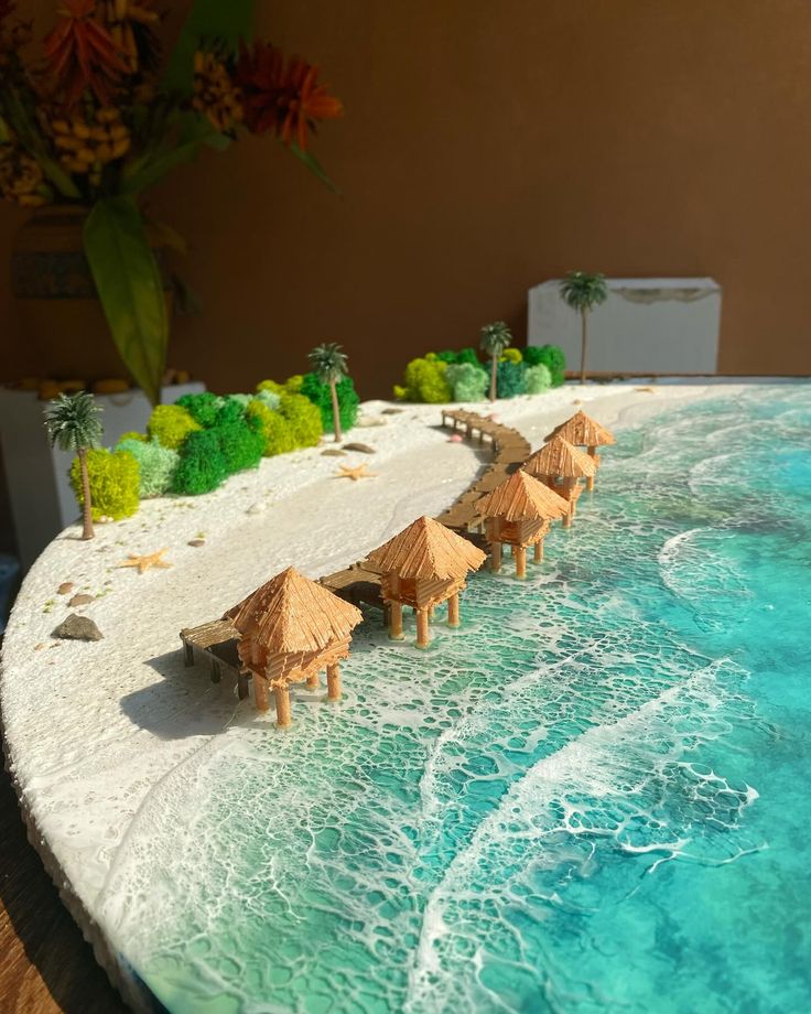 there are some straw umbrellas that are on the beach by the water's edge