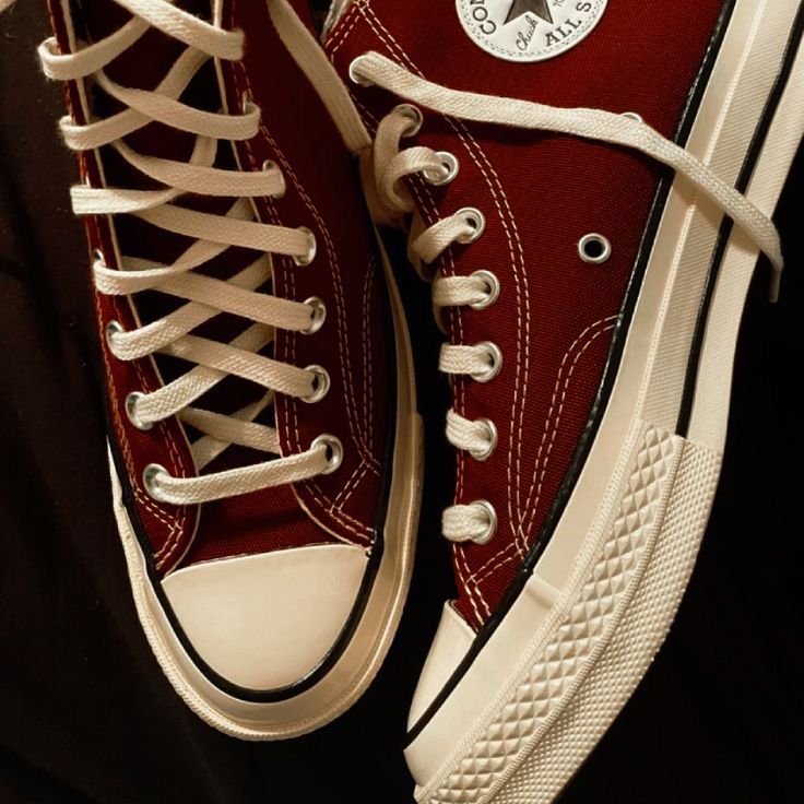 a pair of red and white converse sneakers