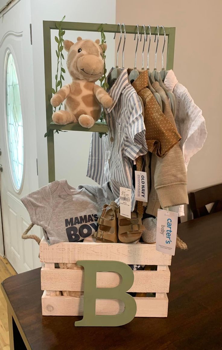 a teddy bear sitting on top of a wooden crate filled with clothes and other items