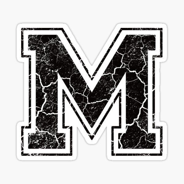 the letter m is made up of cracked black and white paint sticker on a white background