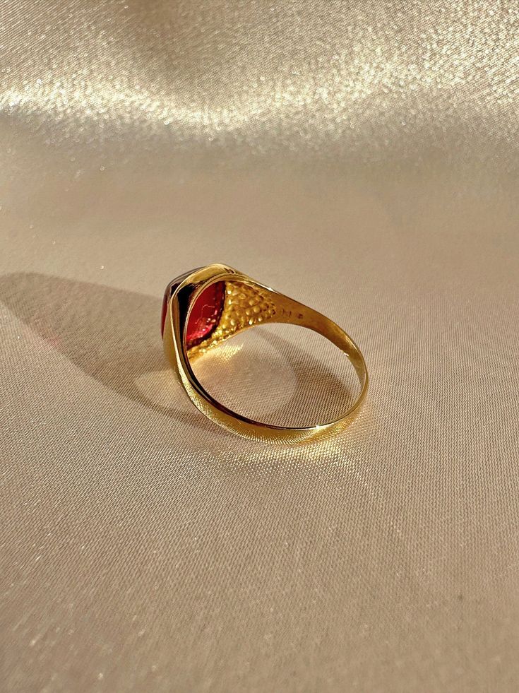 Antique 18k yellow gold ring from the United Kingdom. This signet ring features a vibrant synthetic ruby cabochon. Great antique condition Size: 7.5 resizable* Weight: 3.5 grams Band: 11.1 mm (front), 1.7 mm (back) Synth Ruby: 8.3 mm x 10.0 mm Hallmarks:18CT Vintage Ruby Cabochon Ring, Antique Cabochon Ruby Ring Gift, Antique Ruby Cabochon Ring, Luxury Antique Cabochon Signet Ring, 14k Gold Red Cabochon Ruby Ring, Yellow Gold Ring, 18k Yellow Gold Ring, Signet Ring, Yellow Gold Rings