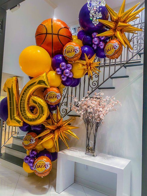 balloons and streamers are arranged in the shape of a basketball, with the number 15 on it