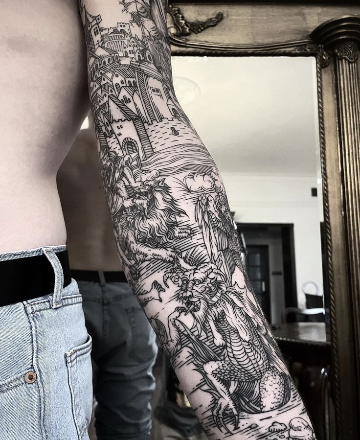 a man's arm with tattoos on it and his reflection in the mirror behind him