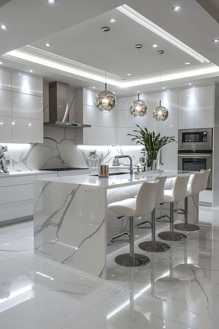 a kitchen with marble counter tops and white chairs around the bar area is lit by recessed lights