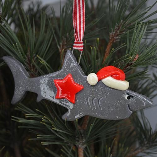 a fish ornament hanging from a christmas tree