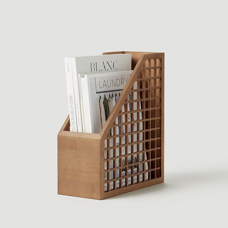 a wooden magazine holder with magazines in it