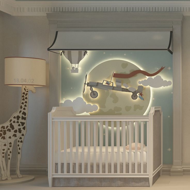 a baby's room with a crib, lamp and giraffe mural