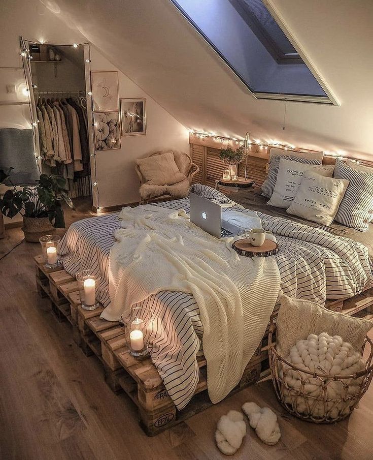 an instagramted photo of a bed with candles on the bottom and lights in the middle