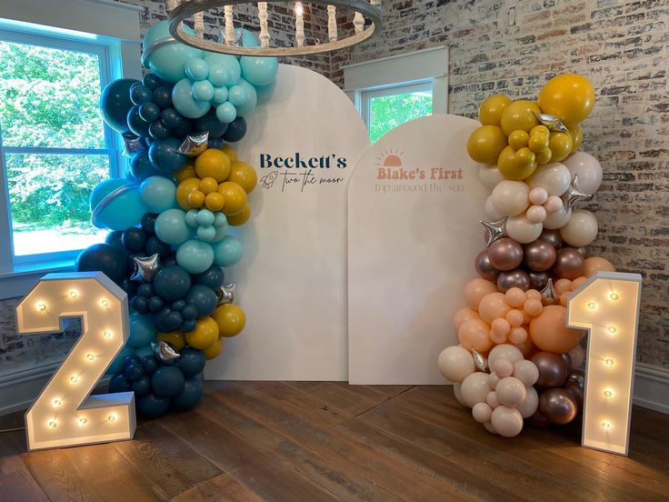 balloons are arranged in the shape of numbers on display at a birthday party for two