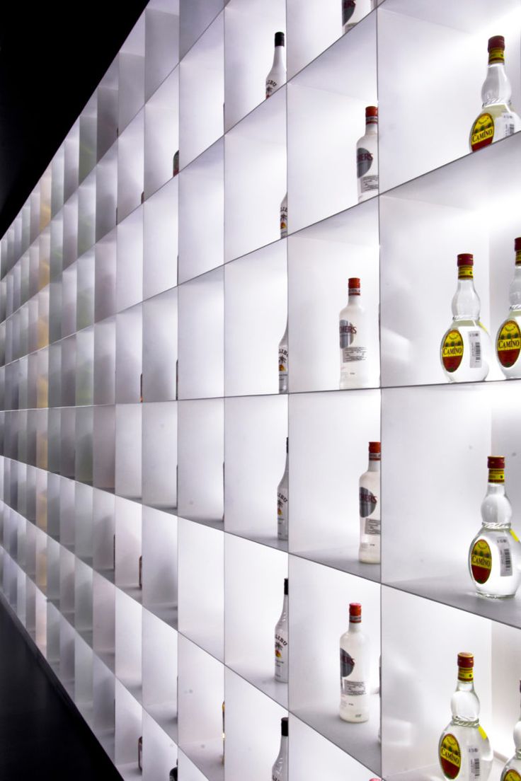 many bottles are lined up on the wall