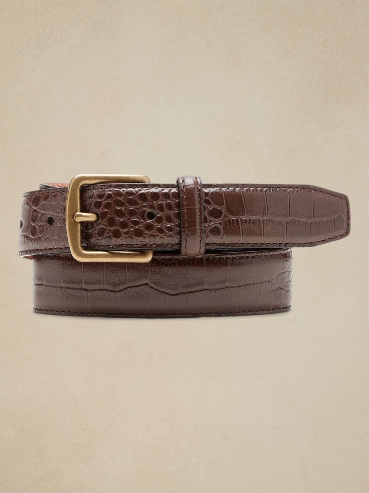 Sleek and streamlined, this embossed leather belt adds a bit of variety to your wardrobe.  LEATHER WORKING GROUP: By purchasing this product, you are supporting responsible leather manufacturing through the Leather Working Group.  Width: 1" (2. 5cm) Leather Brown Belt, Brown Fitted Leather Belt, Fitted Brown Leather Belt, Elegant Formal Belt Buckles With Crocodile Pattern, Elegant Formal Belt Buckle With Crocodile Pattern, Classic Business Belt With Crocodile Pattern, Classic Crocodile Pattern Belts For Business, Classic Crocodile Pattern Business Belts, Luxury Leather Belt Buckles With Crocodile Pattern