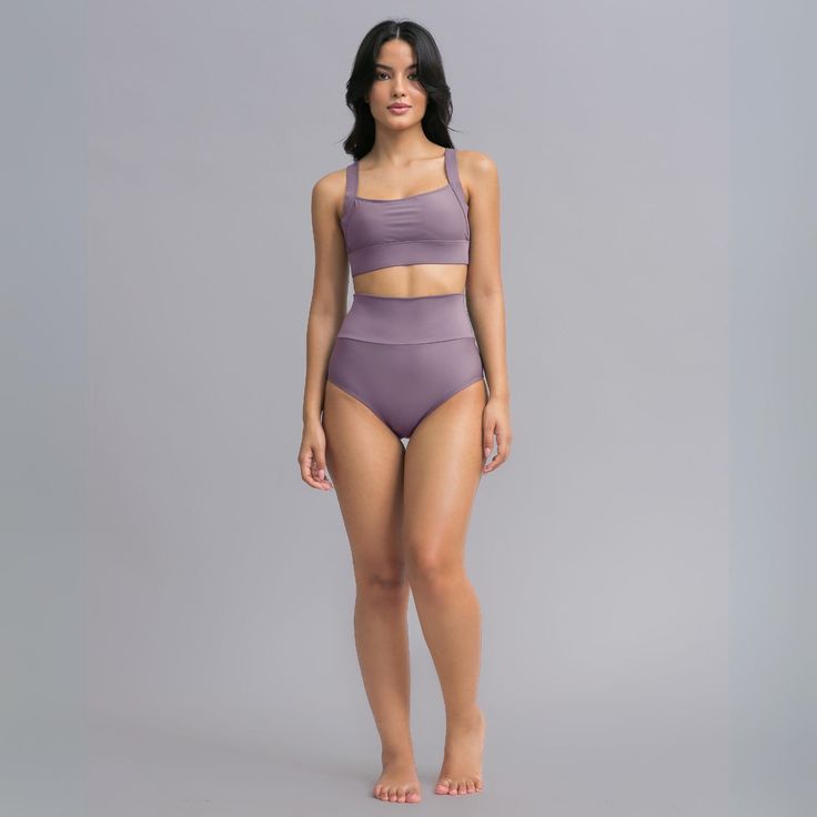 Two-piece swimsuit. Upper: bikini top with thick straps for comfort and support. Fully lined front with removable padded cups. Bra-like back straps for adjustability Bottom: full-coverage bottom with high waist for comfort and support for the tummy area.  -UPF50+ sun protection  -Soft and breathable -Muscle control and shape retention -Two-way stretch for perfect fit  -Pilling resistant -Ultrachlorine resistant 78% ECONYL® regenerated nylon, 22% Elastane.   ECONYL® yarn is a 100% regenerated nyl