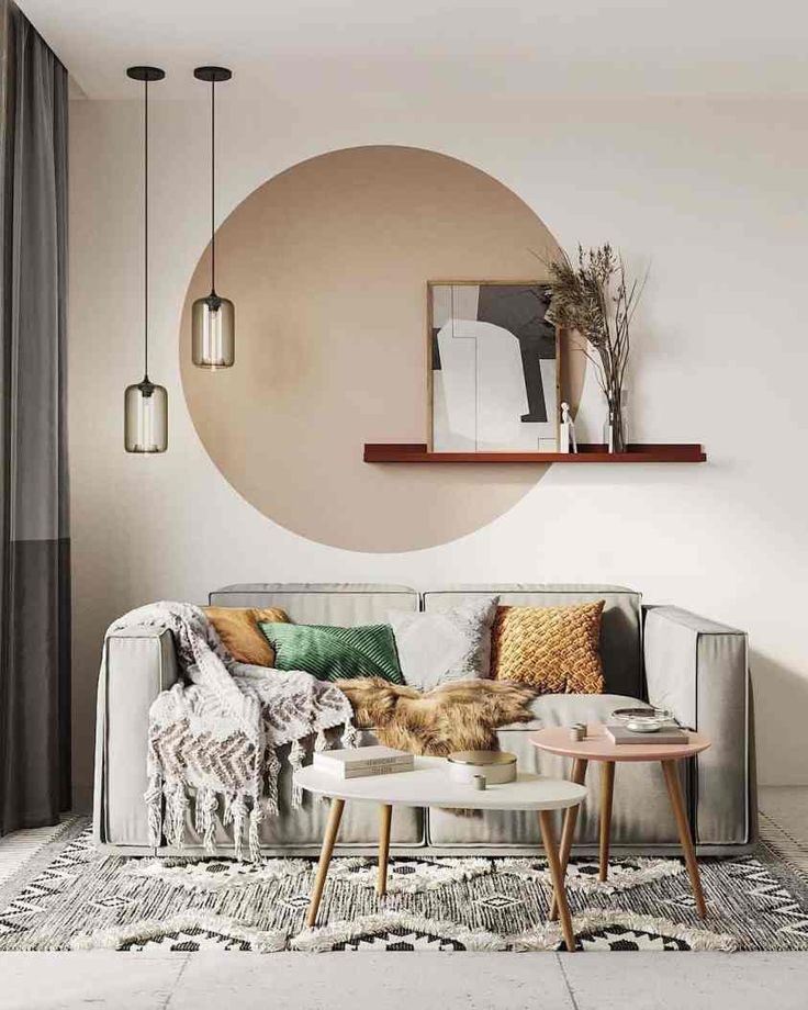 a living room with a couch, coffee table and rugs on the floor in front of a round mirror