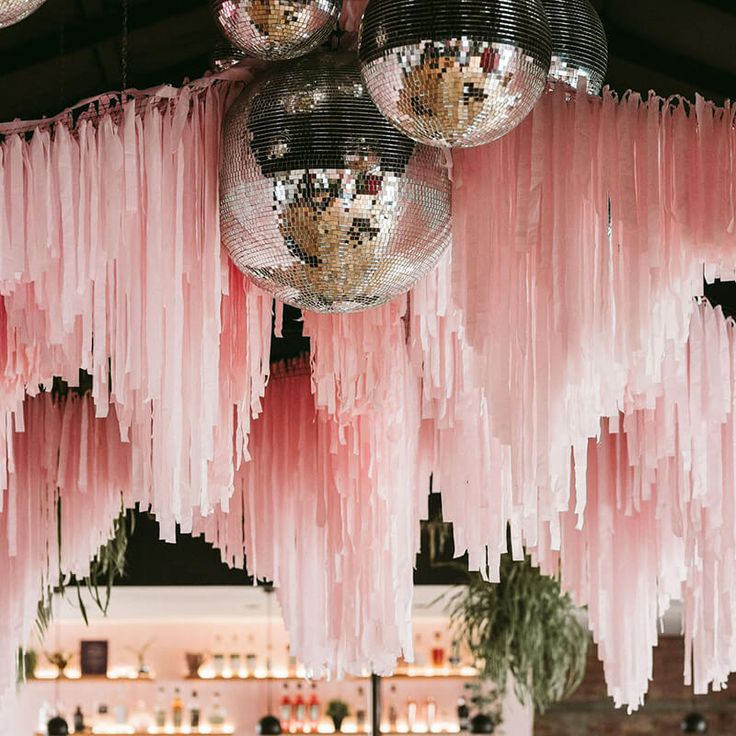 pink and silver decorations hanging from the ceiling