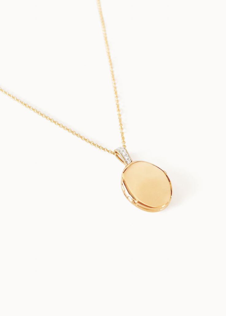 Home is where the heart is. Our Maison Gold Lockets are heirlooms that represent a moment in time. Keep this locket as a family heirloom forever. Wear her blank or get her engraved with your signature letter. To engrave more than one letter, visit HERE.Already have a chain? To purchase the locket individually, visit HERE. Photo dimensions: 14mm x 11.5mmTo add a photo inside, simply open the locket and carefully press the photo into place. Our lockets do not have a separate opening for a photo. F Luxury Polished Pendant Locket Necklace, Heirloom White Gold Locket Necklace, Elegant Oval Link Locket Necklace, Luxury Yellow Gold Oval Locket Necklace, Heirloom Medallion Diamond Jewelry, Formal White Gold Oval Pendant Locket Necklace, Luxury Oval Pendant Locket Necklace As Gift, Classic Oval Link Locket Jewelry, Elegant Diamond Locket Necklace