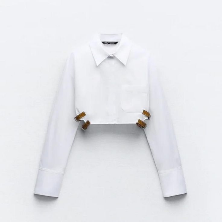 New With Tag Zara S/S 2024 Collection Shirt Made Of Gabardine. Lapel Collar And Long Cuffed Sleeves. Straps At Side Hem With Metal Buckle. Front Button Closure. White 7385/003 Outer Shell 100% Cotton Clothing Care Guide: Machine Wash Max. 30c/86f Delicate Cycle Do Not Use Bleach / Whitener Iron Maximum 110c/230f Tetrachloroethylene Dry Clean Do Not Tumble Dry White Cropped Shirt For Fall, Elegant White Button-up Cropped Shirt, White Button-up Cropped Shirt For Fall, Chic White Long Sleeve Cropped Shirt, White Collared Zara Shirt, White Cropped Collared Shirt For Spring, White Cropped Shirt With Collar For Spring, Chic White Collared Cropped Shirt, White Fitted Cropped Shirt For Fall