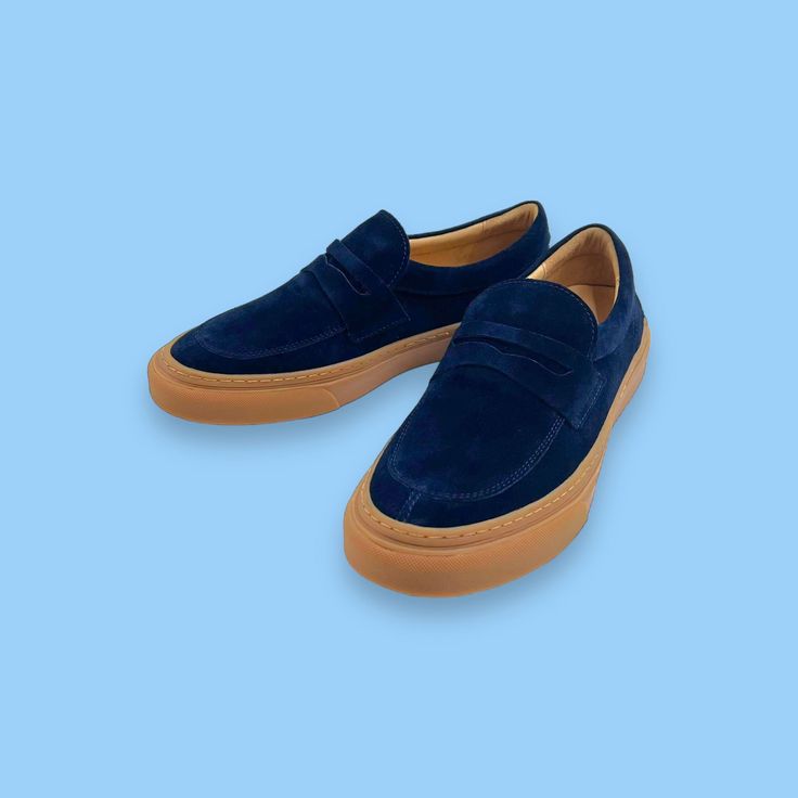 - Premium suede upper - Easy slip-on design - Leather lined - Rubber outsole with unsurpassed comfort and flexibility Blue Slip-on Leather Shoes With Suede Lining, Blue Suede Slip-on Leather Shoes, Suede Leather Slip-on Shoes With Contrast Sole, Blue Suede Loafers With Suede Lining, Navy Suede Round Toe Sneakers, Navy Suede Sneakers With Round Toe, Blue Suede Moccasins With Stitched Sole, Modern Blue Loafers With Textured Sole, Navy Suede Loafers For Formal Occasions